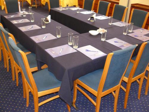 a long table with blue tables and chairs at Nicotel Barletta in Barletta