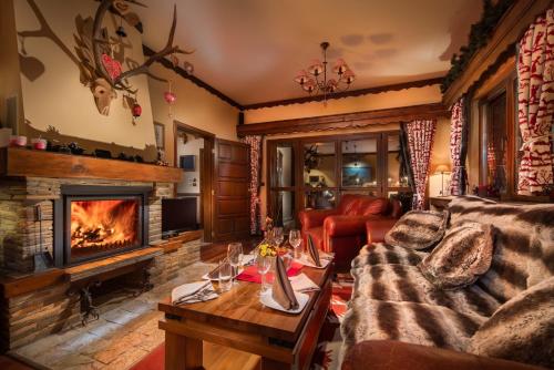 a living room with a couch and a fireplace at Villa Borovets Mountain & Luxury in Borovets