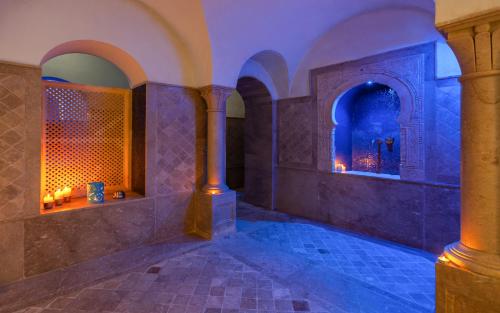 a room with blue lighting in a building with columns at Dar Dorra in Tunis