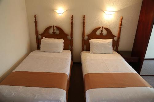 Postel nebo postele na pokoji v ubytování Alcalá Apart Hotel