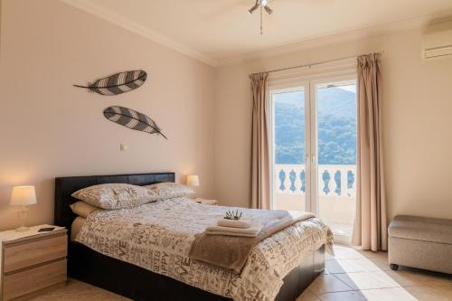 a bedroom with a bed and a large window at Villa Clearvue 