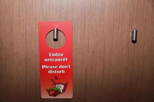 a tag on a door with a sign on it at Hotel Dobele in Dobele