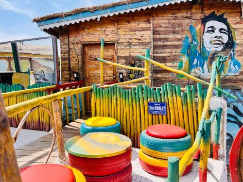 a group of colorful stools in front of a building at Maison du Bonheur in Dakar