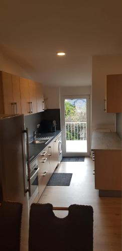 a kitchen with a stove and a sink and a window at Joanna Apartment - Worms in Worms