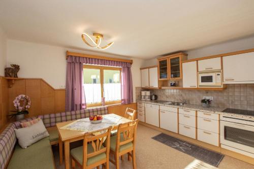 a kitchen with a table and a dining room at Appartementhaus Radstadt in Radstadt
