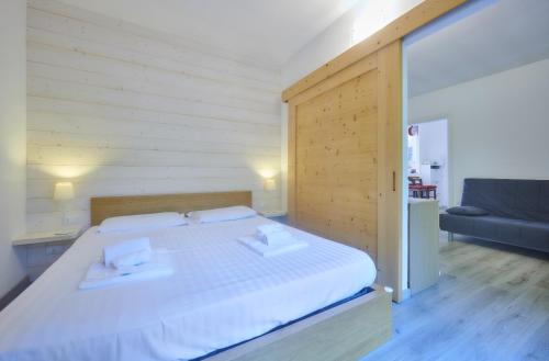 a bedroom with a large bed with two pillows on it at Nicola Flat in Lierna