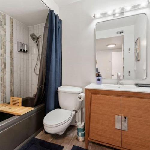 a bathroom with a toilet and a sink and a mirror at Panorama Place in Reno