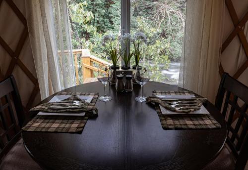 a dining room table with chairs and a window at stayNantahala - Smoky Mountain Cabins in Aquone