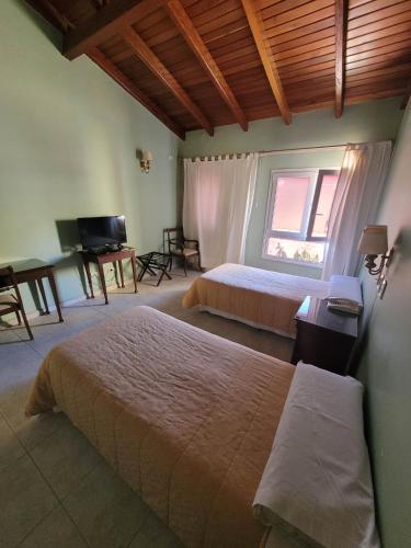 Una cama o camas en una habitación de Hotel Pórtico Norte