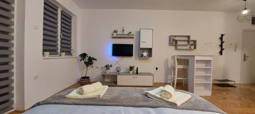 a bedroom with a bed with two pillows on it at Apartman Bart in Subotica