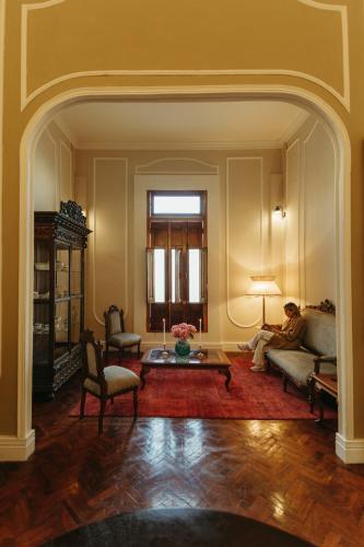 a man sitting on a couch in a living room at Plaza Central in Arequipa