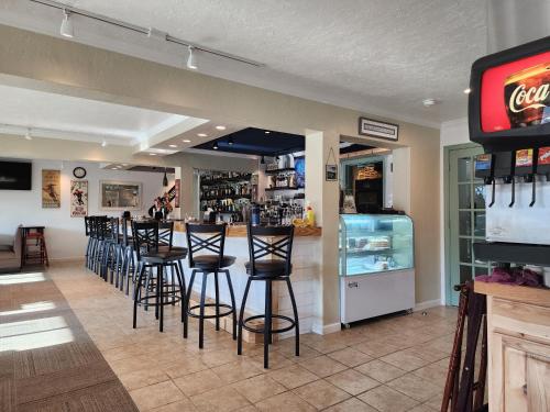 a bar with black stools in a restaurant at Top of the Beech Inn in Beech Mountain