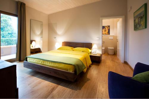 a bedroom with a bed and a large window at Villa Bedin in Fontanafredda