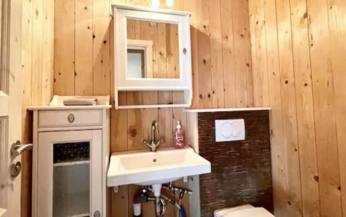 a bathroom with a sink and a mirror at Hidden Cottages in Kvíabekkur