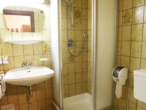 a bathroom with a sink and a shower at Gasthof Pension Madseiterhof in Tux