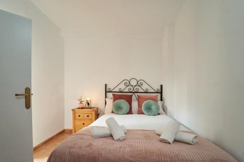 a bedroom with a large bed with red pillows at La Ruteña in Rute