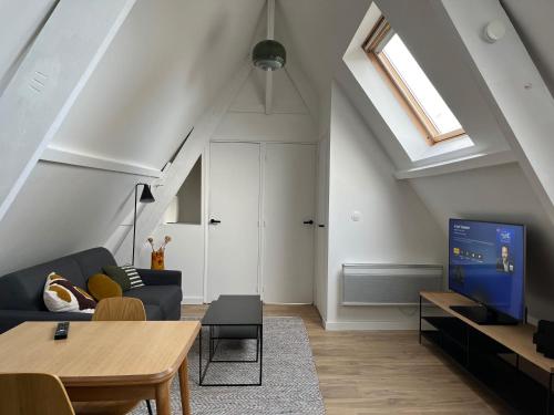 un salon avec un canapé et une télévision dans l'établissement Le426, Charmant F2 refait à neuf, à Mouvaux