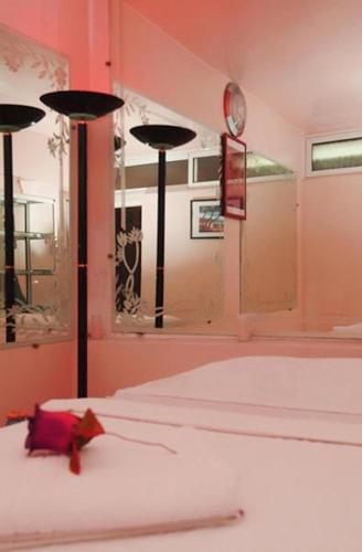 a bedroom with two beds and a large mirror at Perla Hôtel in Fès