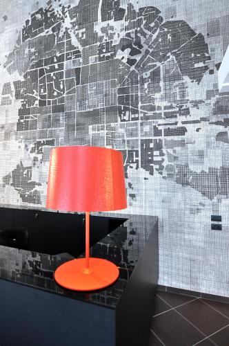 a red lamp sitting on a table in front of a wall at BB Hotels Aparthotel Arcimboldi in Milan