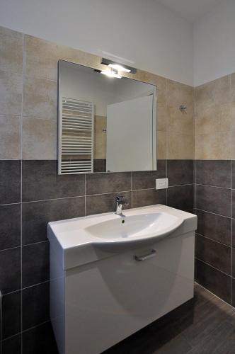 a bathroom with a white sink and a mirror at BB Hotels Aparthotel Arcimboldi in Milan