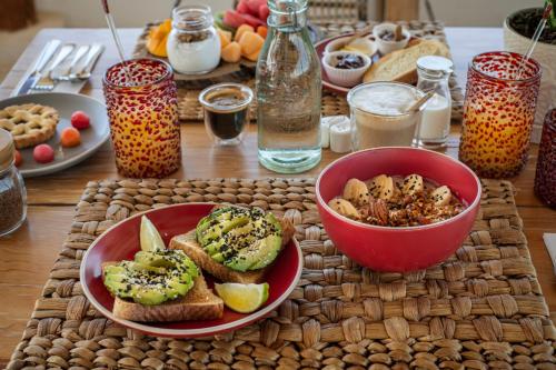 a table with a plate of bread and a bowl of food at El Corazón Boutique Hotel - Adults Only with Beach Club pass included in Holbox Island