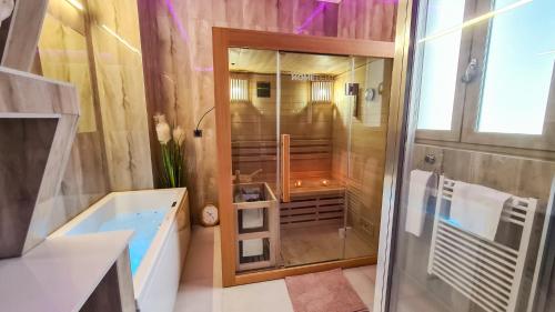 a bathroom with a shower and a tub and a sink at GOLDIE in Zagreb