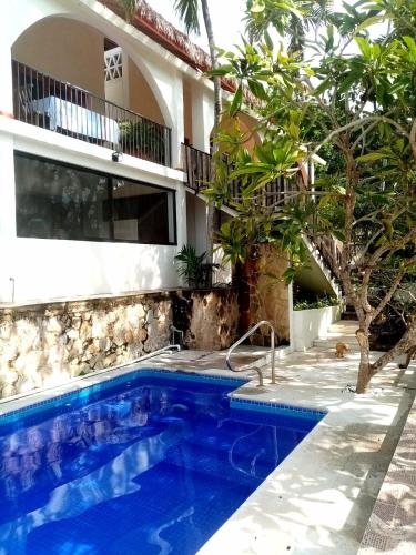 a swimming pool in front of a house at Casa Maria en La Manzanilla in La Manzanilla