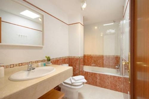 a bathroom with a sink and a toilet and a shower at Casa Princesa Gara in Yaiza