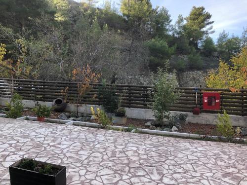 a garden with a fence and some plants at DIAMOND Stone Wooden Guest House in Khandria