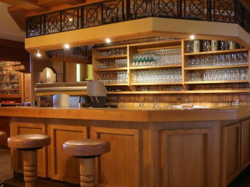 a bar in a restaurant with stools at Gasthof Pension Madseiterhof in Tux