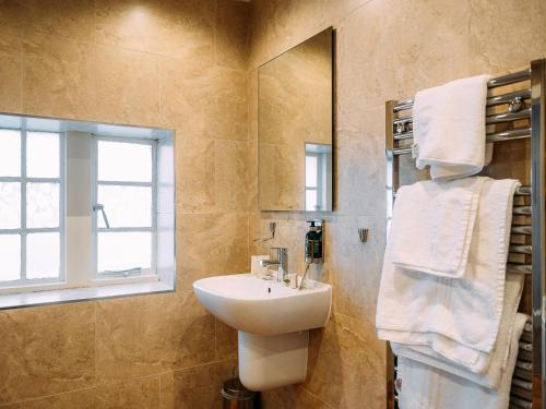 a bathroom with a sink and a mirror at The Lodge in Clitheroe