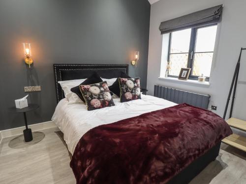 una camera da letto con un grande letto con cuscini sopra di Jasmine a Hull