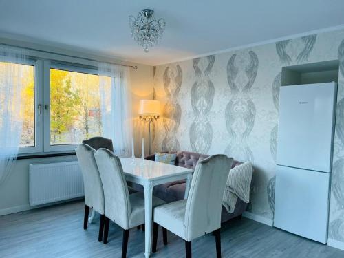 a dining room with a table and chairs at LeCiel Maison Lily in Bad Lauterberg