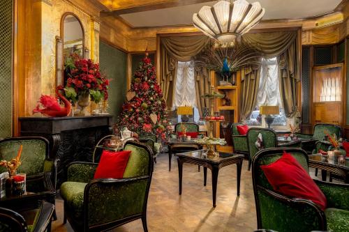 a living room with a christmas tree and a fireplace at Boutique Hotel De Castillion - Small elegant family hotel in Bruges