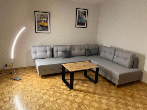 a living room with a couch and a coffee table at Mieszkanie z widokiem na Görlitz in Zgorzelec