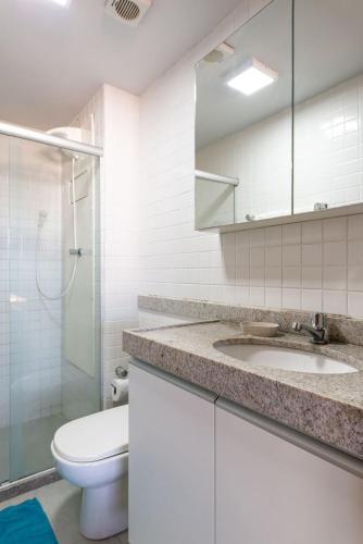 a bathroom with a toilet and a sink and a shower at Praia Central Porto de Galinhas in Porto De Galinhas