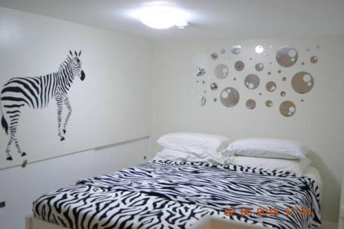 a bedroom with a zebra mural on the wall at SMDC Wind Loft Bedroom 101 Facing Amenities with WIFI and Parking in Tagaytay