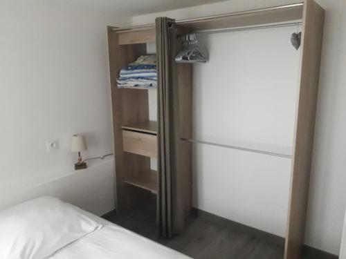 a bedroom with a bed and a closet with a door at Citad' Yeu in Port-Joinville