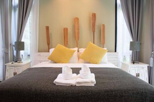 a bedroom with a bed with towels on it at Snapper House in Khao Lak