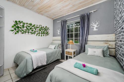 a bedroom with two beds and a window at 302 On Old Sea View Road Chelsea in Port Elizabeth