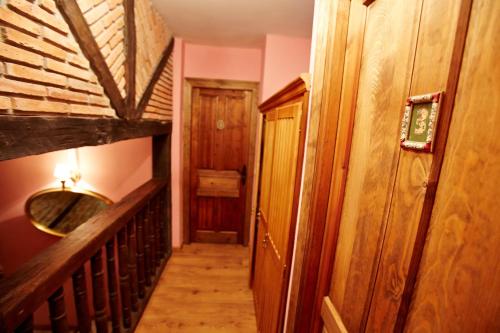 a hallway of a house with a wooden staircase at Posada Rural Ochohermanas in Las Fraguas
