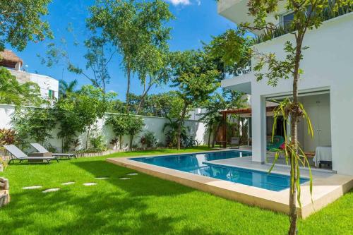 a swimming pool in the yard of a house at Luxury Private 3BED Villa, Garden, Pool,Security in Tulum