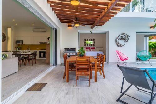 a dining room and living room with a table and chairs at Luxury Private 3BED Villa, Garden, Pool,Security in Tulum