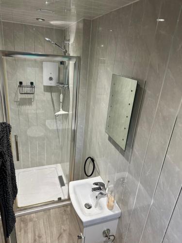 a small bathroom with a sink and a shower at B3 Rickardos Holiday Lets in Mablethorpe