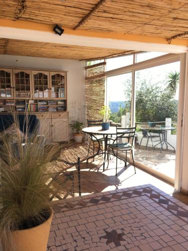 a patio with a table and chairs on a patio at Varandas do Vale Furnazinhas in Castro Marim