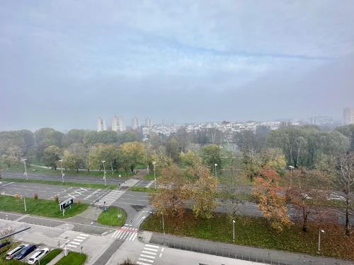 a view of a parking lot with a city in the background at Penthouse one bedroom with a view of Zagreb in Zagreb