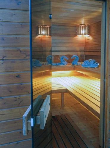 a sauna with a bench in a wooden wall at Velem Spirit Apartment in Velem