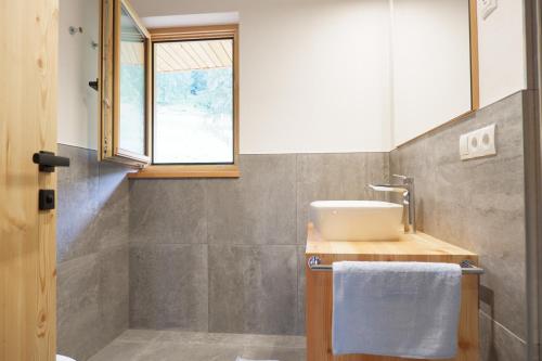 a bathroom with a sink and a window at Wolfhof_Ritten in Auna di Sopra