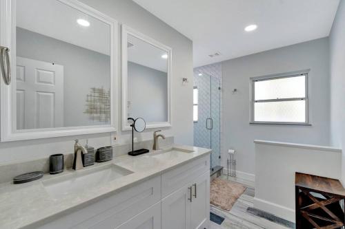 a white bathroom with a sink and a fireplace at Paradise By The River-Hottub/Pool-Near Beaches in Bradenton