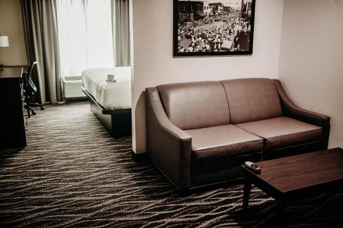a hotel room with a couch and a bed at Cobblestone Hotel & Suites International Falls in International Falls
